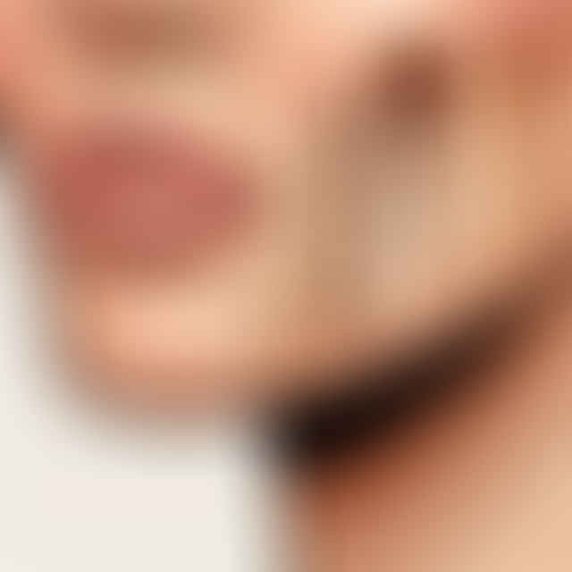 close-up of foundation swatches on someone's jawline